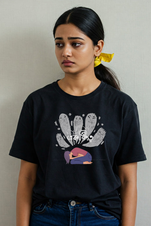 Person wearing a black t-shirt with a graphic design on a plain background