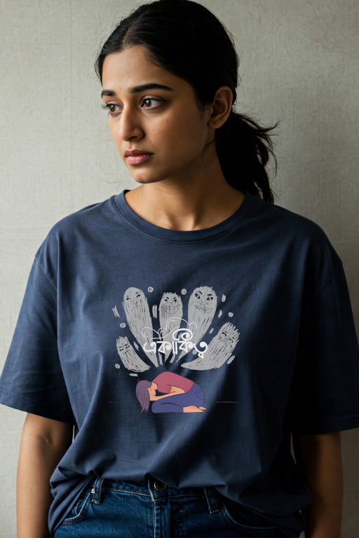 Person wearing a navy blue t-shirt with a graphic design on a plain background