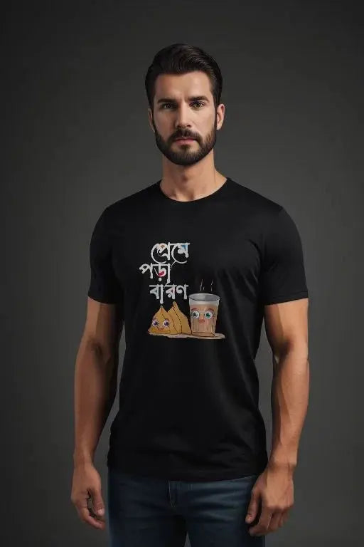 Man wearing a black t-shirt with a graphic design on a dark background