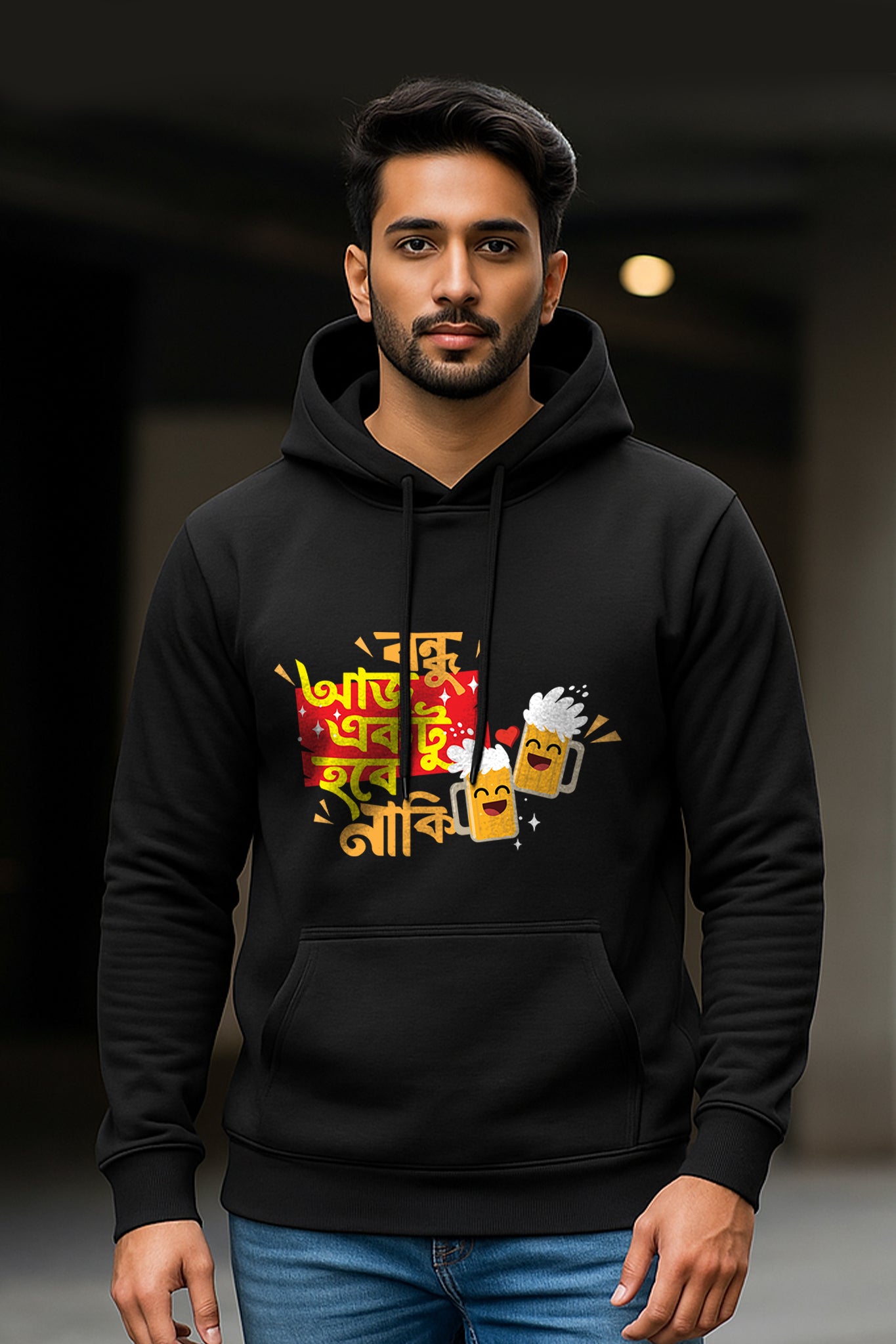 Man wearing a black hoodie with colorful graphics and text on a dark background
