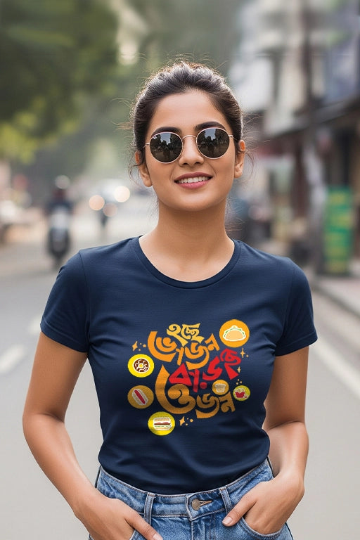 Woman wearing a navy blue t-shirt with colorful graphics on a street background