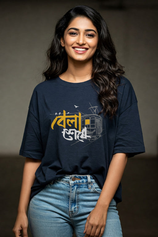 Woman wearing a navy blue t-shirt with yellow and white text, standing against a plain background