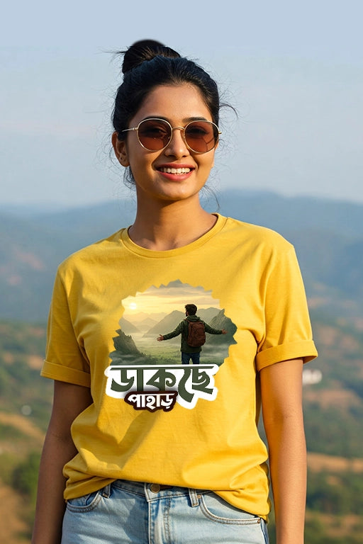 Woman wearing a yellow t-shirt with a graphic design outdoors